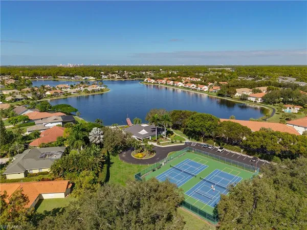 an aerial view of a houses with a lake view