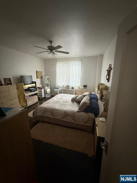 210 Hoboken Road, Unit 2A East Rutherford, NJ 07073 - Photo 6 of 15 a bedroom with a bed and a chandelier