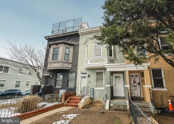 a front view of a house with many windows