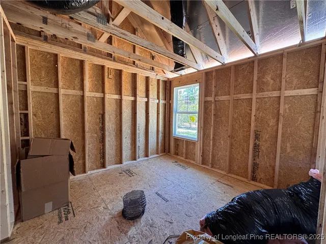 a living room with furniture a window and gym equipment