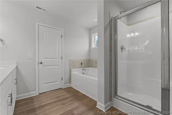 a bathroom with a sink toilet tub and shower