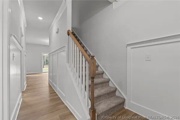 a view of a hallway with wooden floor and entryway