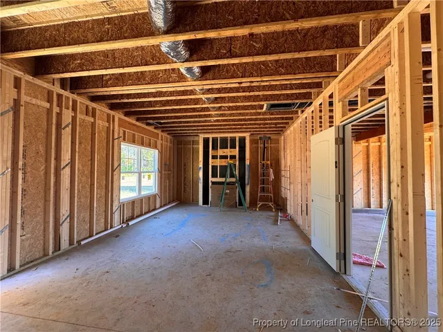 a view of walk in closet with window and bathroom
