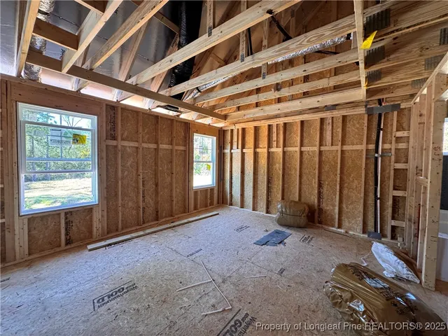 a view of a hallway with wooden walls and windows