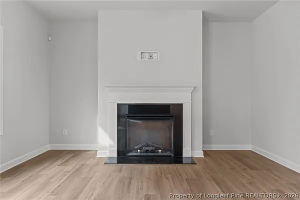 a room with a fireplace and wooden floor