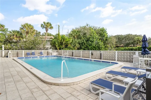 a kitchen with white cabinets and sink