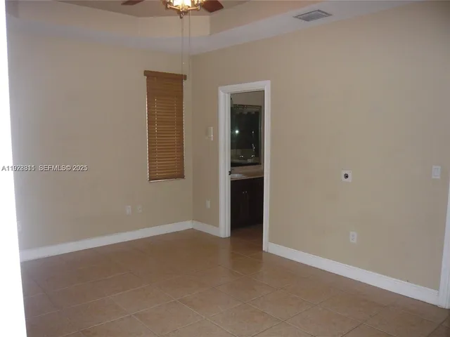 an empty room with a empty space and a ceiling fan