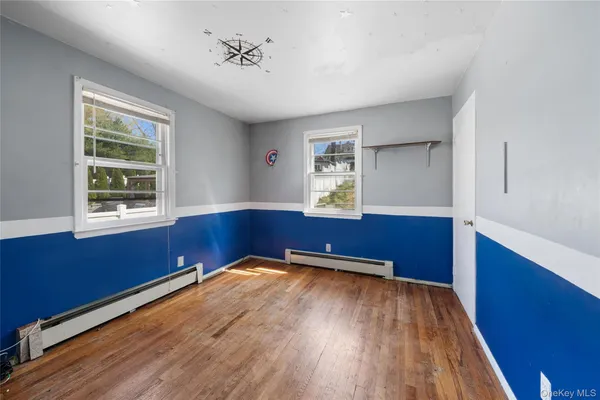 a room with a window and wooden floor