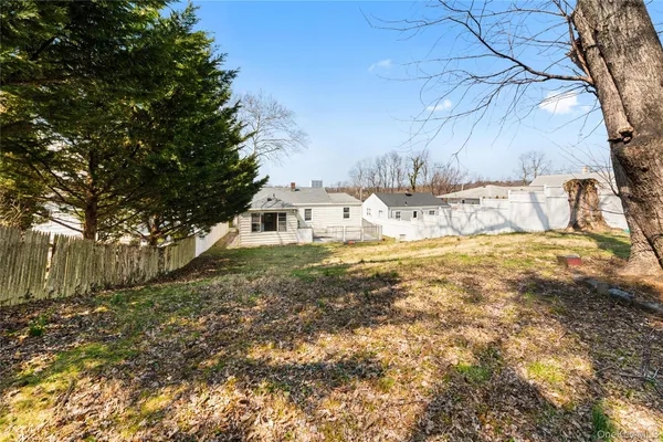 a view of yard covered with snow in front of house