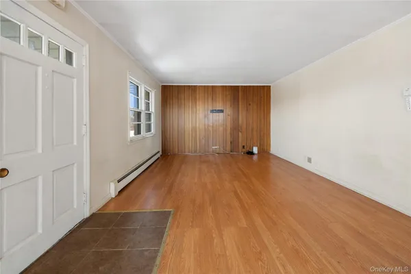 a view of a livingroom with wooden floor and stairs