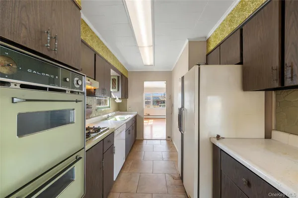 a kitchen with stainless steel appliances a refrigerator sink and cabinets