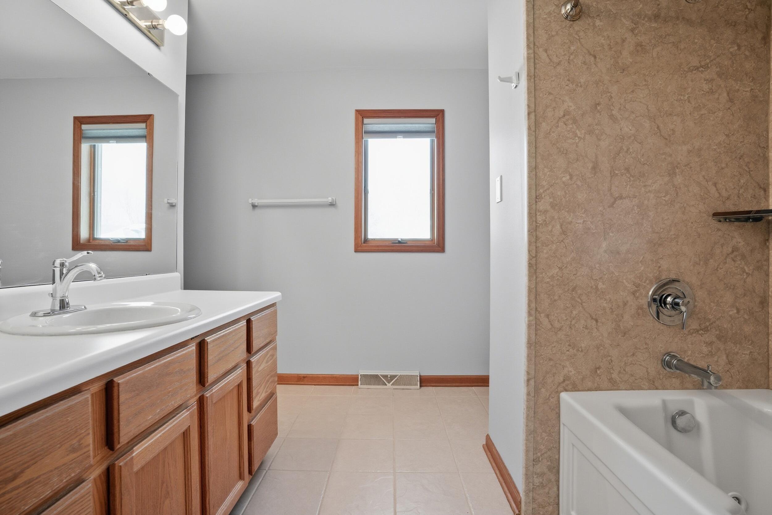 5125 Cardinal Court Schererville, IN 46375 - Photo 13 of 27 a bathroom with a tub sink and mirror