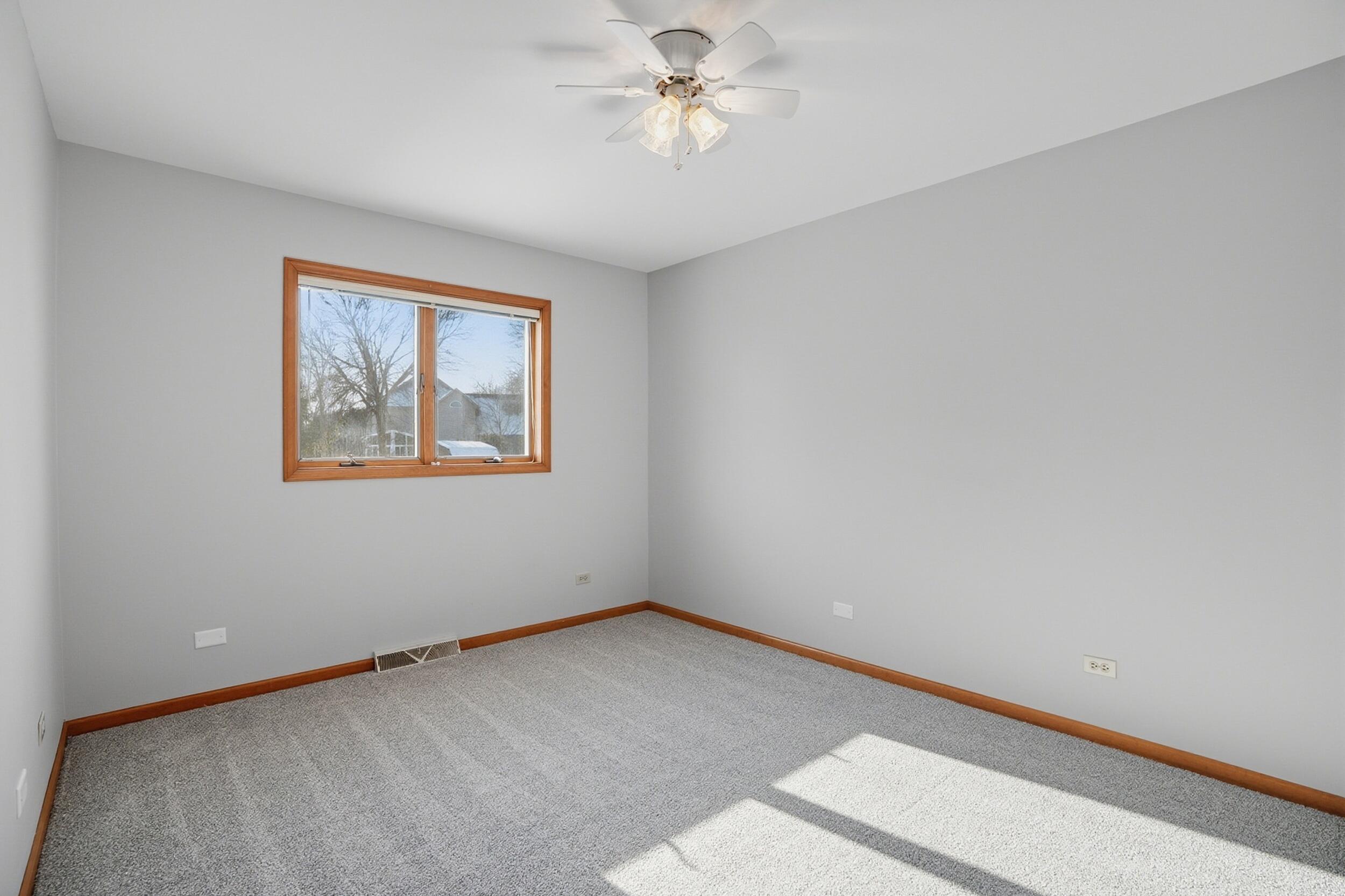 5125 Cardinal Court Schererville, IN 46375 - Photo 15 of 27 an empty room with a window and a fan