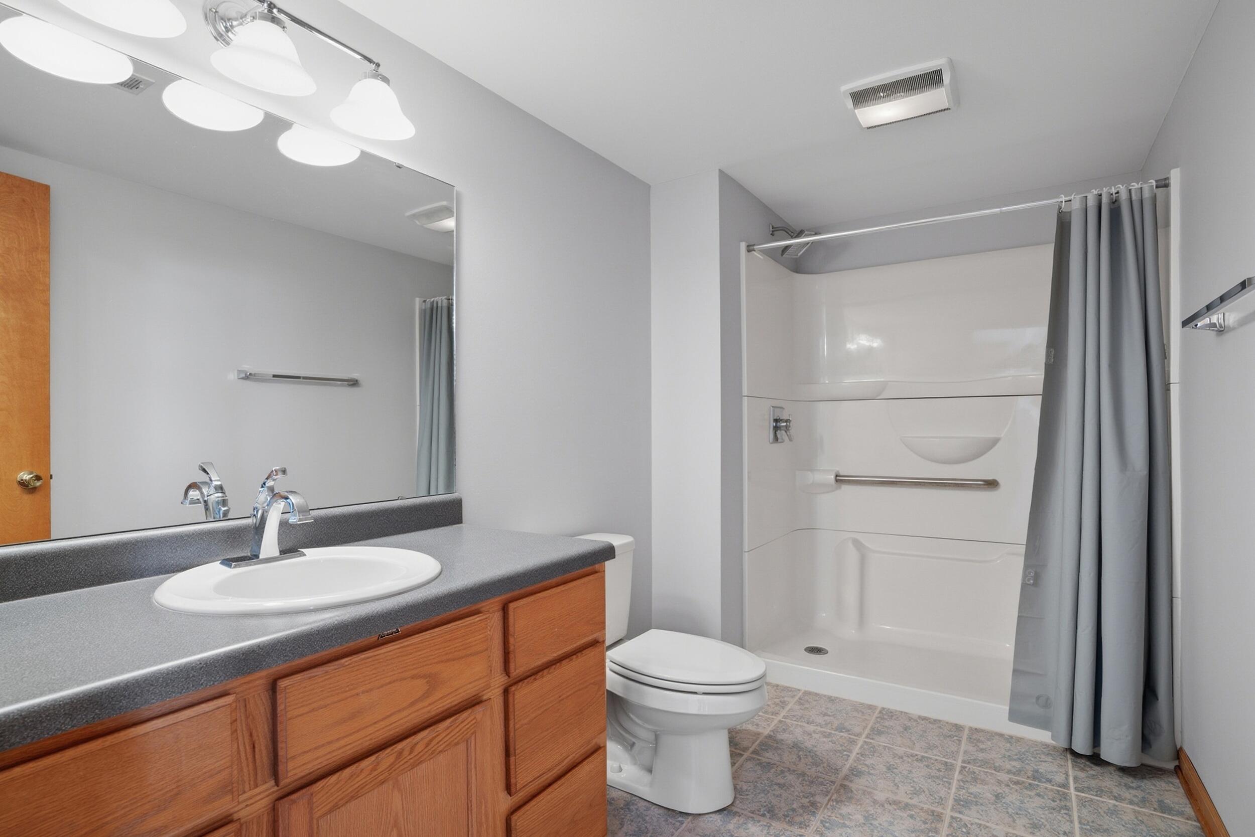 5125 Cardinal Court Schererville, IN 46375 - Photo 19 of 27 a bathroom with a granite countertop sink toilet and shower