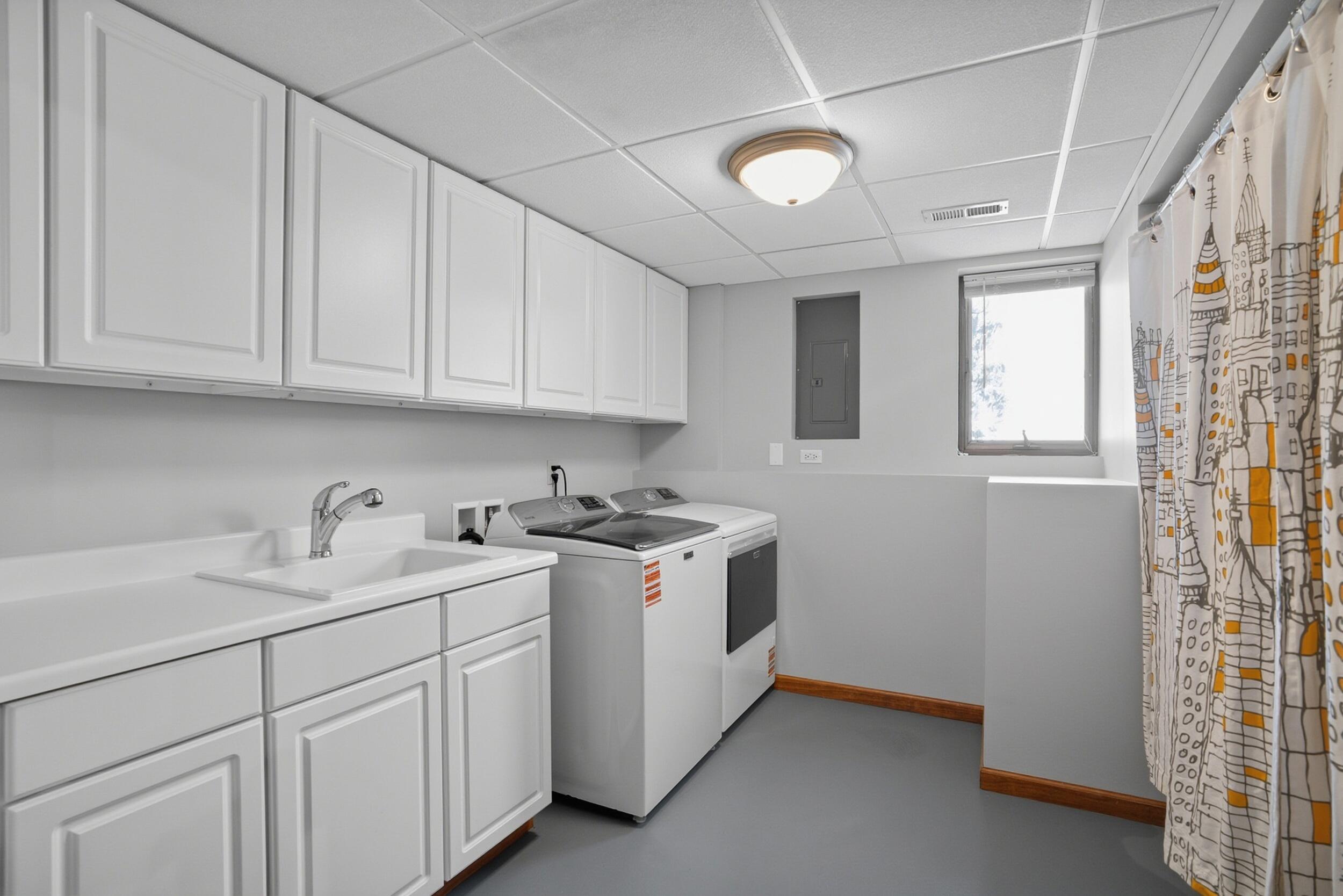 5125 Cardinal Court Schererville, IN 46375 - Photo 23 of 27 a kitchen with cabinets appliances a sink and a window