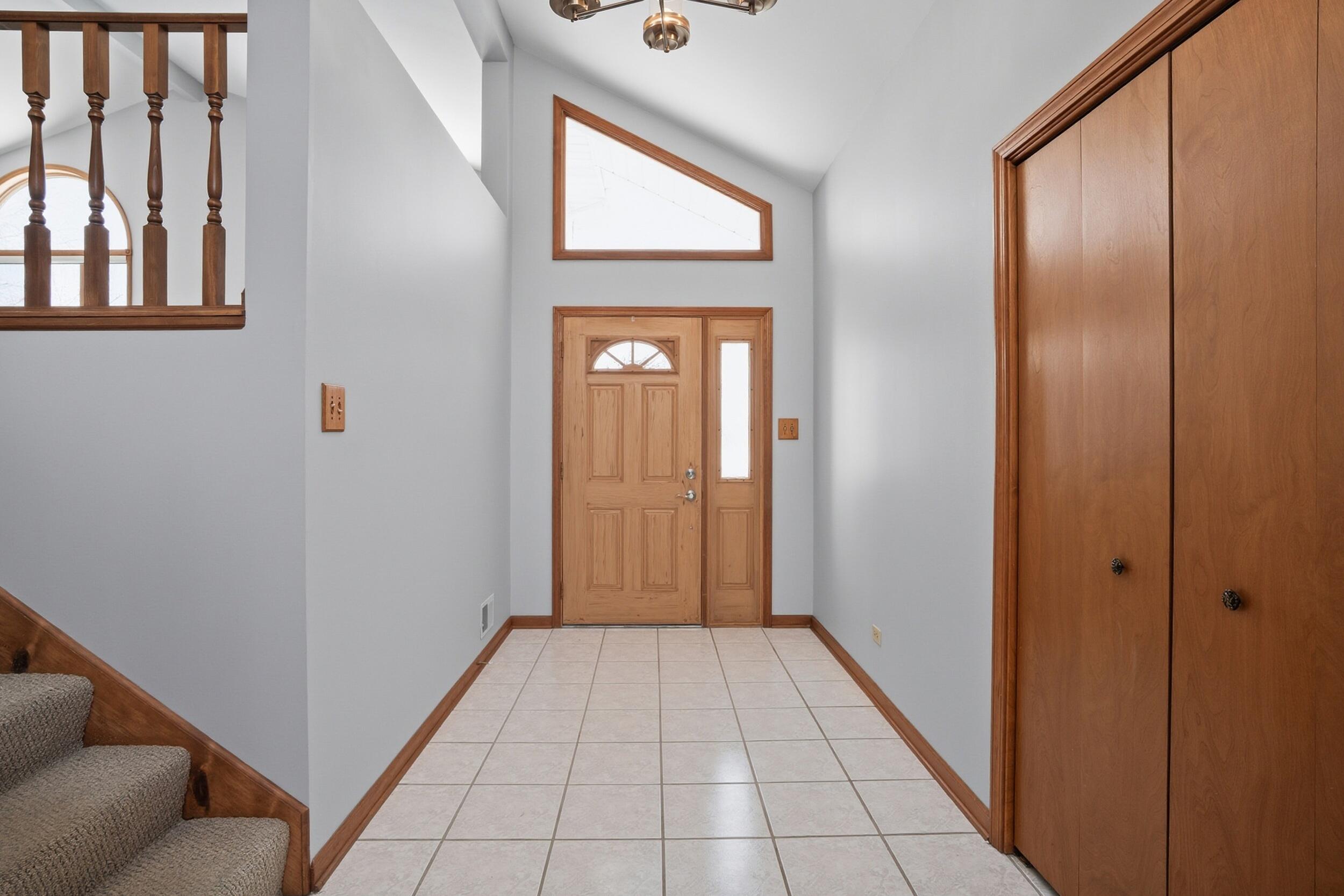 5125 Cardinal Court Schererville, IN 46375 - Photo 4 of 27 a view of a hallway with wooden floor and staircase
