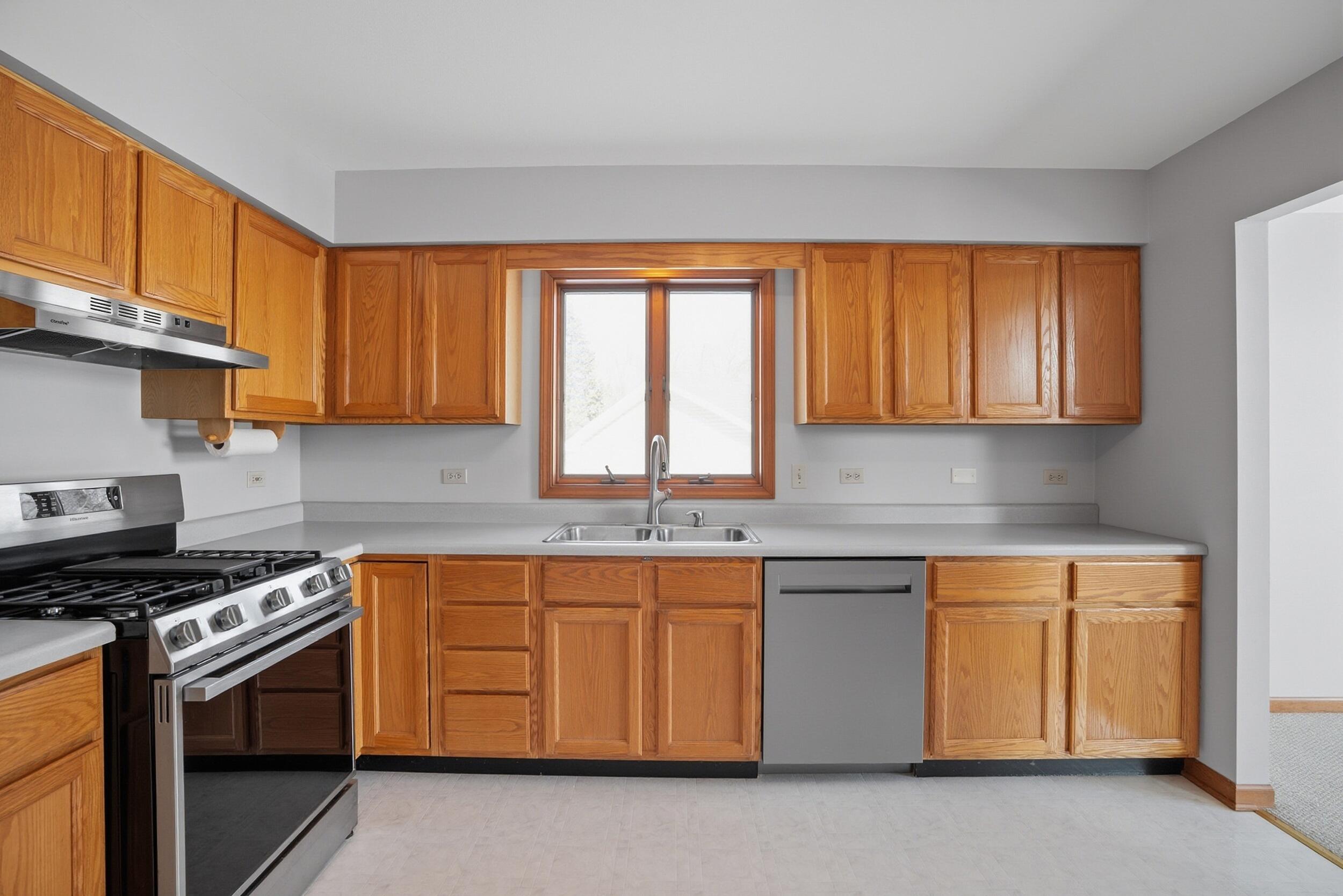 5125 Cardinal Court Schererville, IN 46375 - Photo 10 of 27 a kitchen with stainless steel appliances granite countertop a stove a sink and a microwave