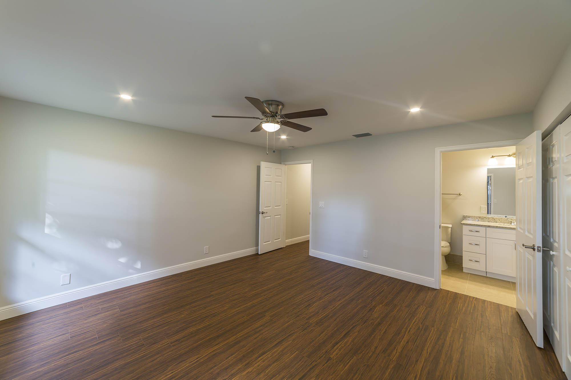 6337 Lasalle Road Delray Beach, FL 33484 - Photo 11 of 15 a view of an empty room with wooden floor and a ceiling fan