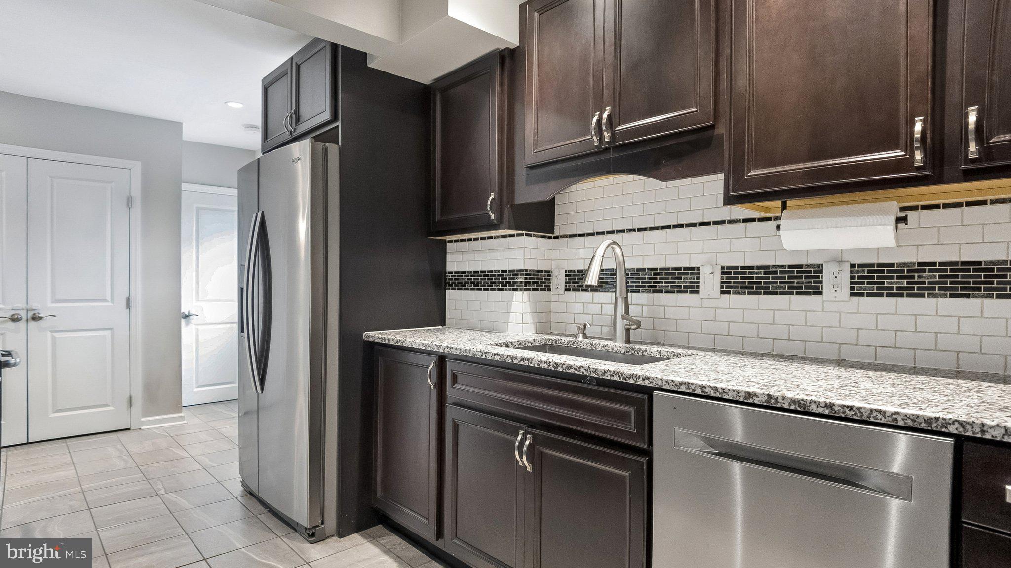 629 Willowbrook Road Havertown, PA 19083 - Photo 13 of 33 a kitchen with stainless steel appliances granite countertop a sink and a refrigerator