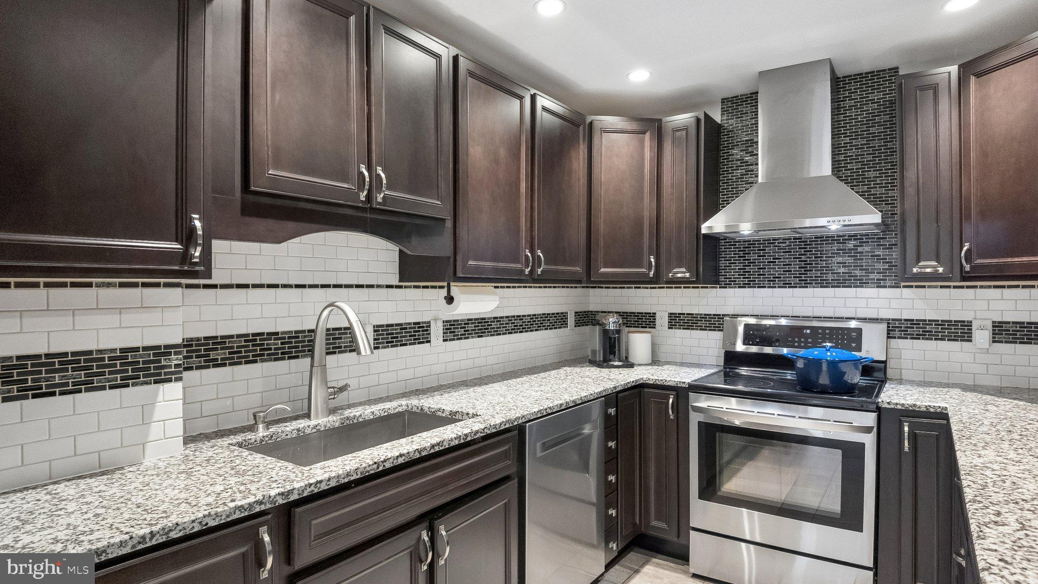 629 Willowbrook Road Havertown, PA 19083 - Photo 14 of 33 a kitchen with granite countertop stainless steel appliances a sink a stove and a counter top space