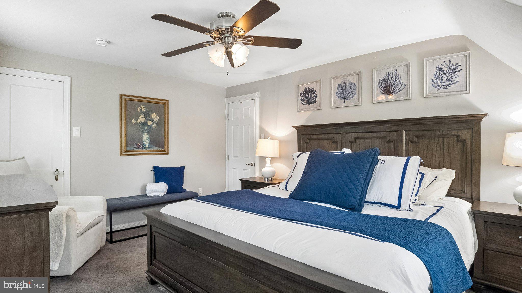 629 Willowbrook Road Havertown, PA 19083 - Photo 18 of 33 a bedroom with a large bed and a chandelier