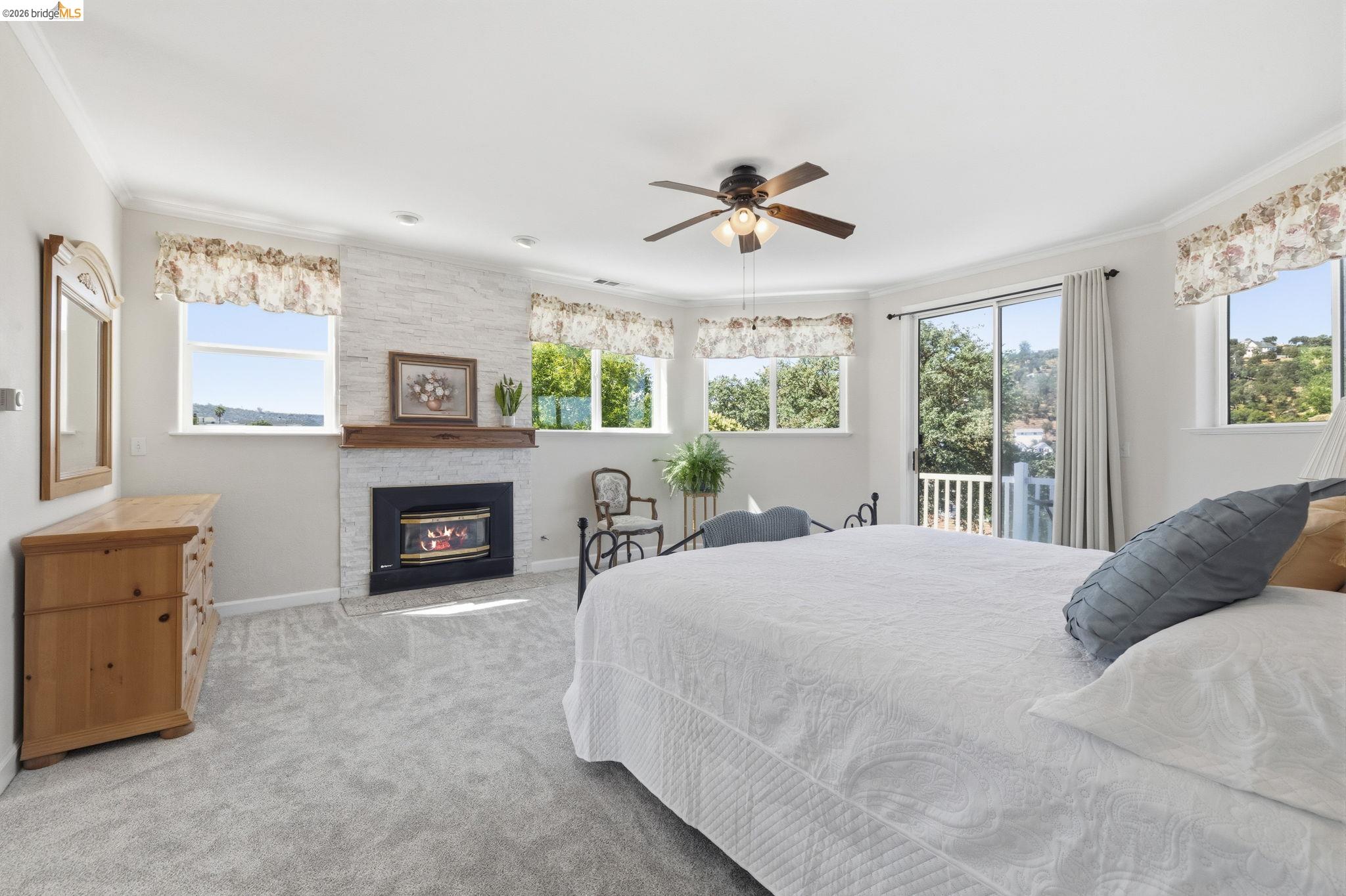 6242 Bluff View Road Copperopolis, CA 95228 - Photo 29 of 59 Newly carpeted huge bedroom featuring a fireplace with a wood mantle and stone surround