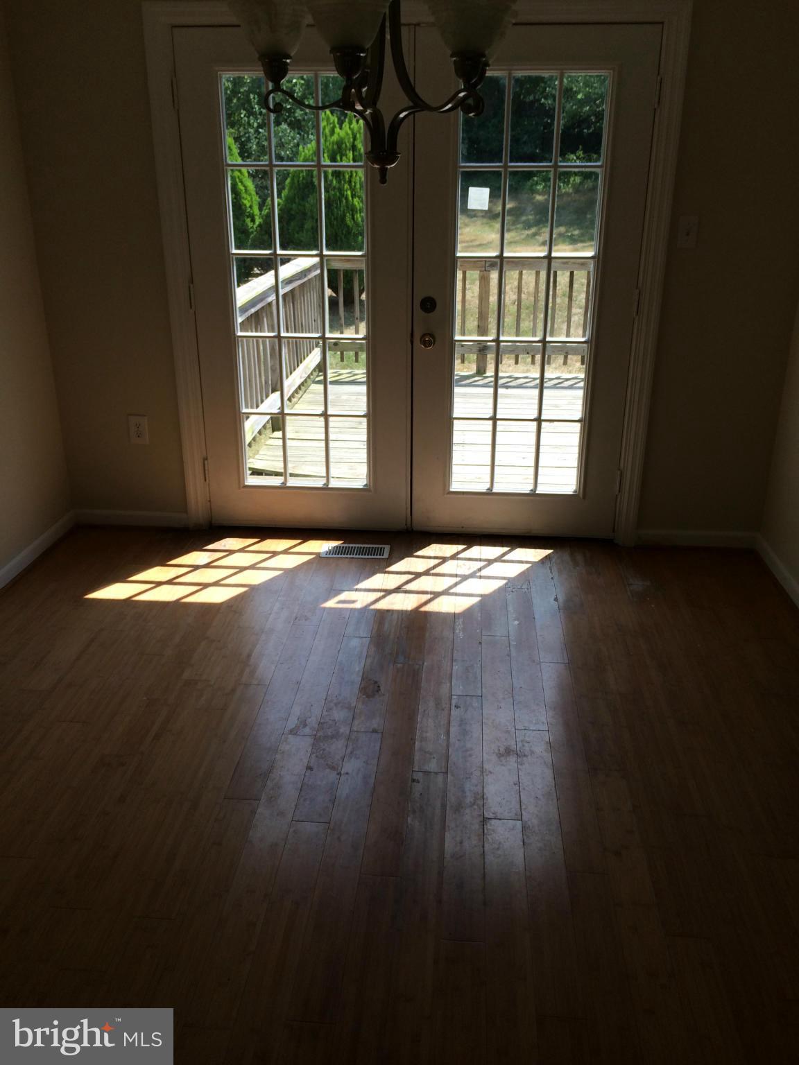 3513 Chado Road Clinton, MD 20735 - Photo 2 of 6 a view of an empty room with wooden floor and a window