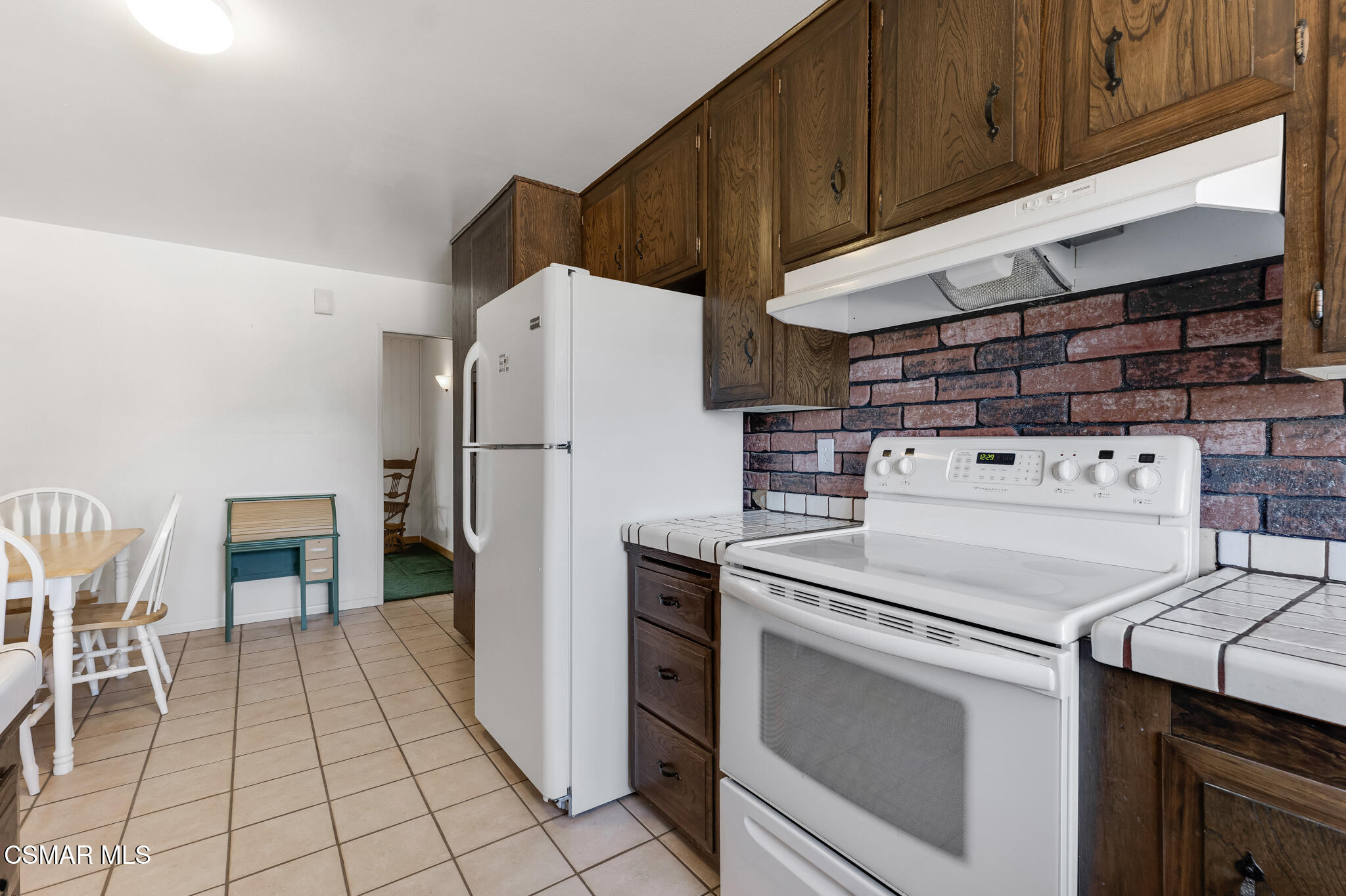 3493 Amarillo Avenue Simi Valley, CA 93063 - Photo 15 of 49 a kitchen with a stove top oven and cabinets