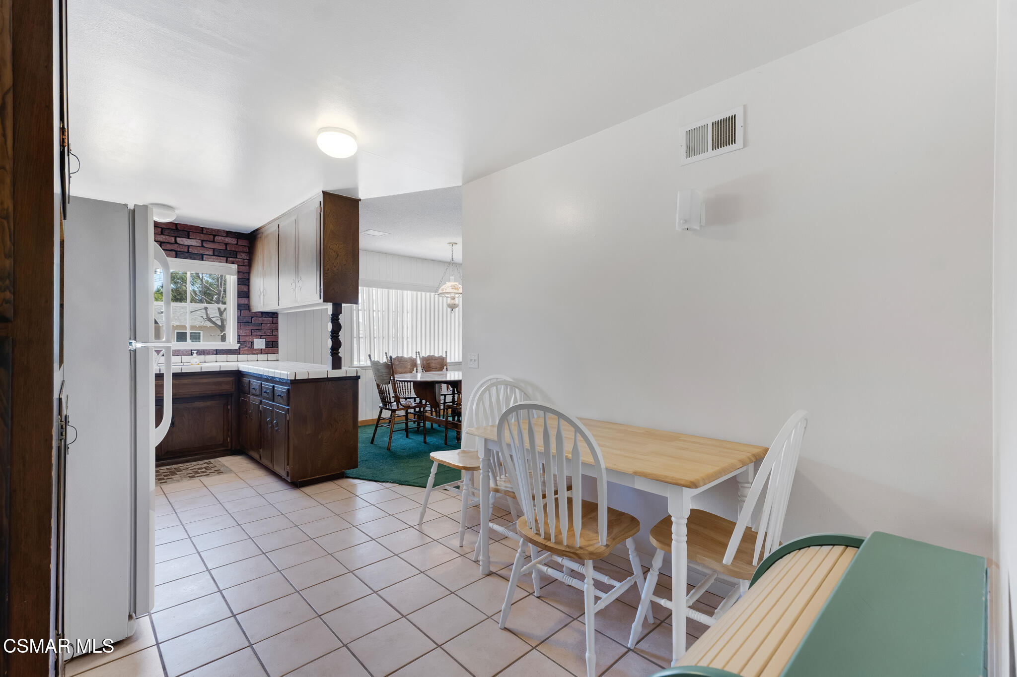 3493 Amarillo Avenue Simi Valley, CA 93063 - Photo 17 of 49 a kitchen with stainless steel appliances kitchen island granite countertop a refrigerator a sink a stove a dining table and chairs