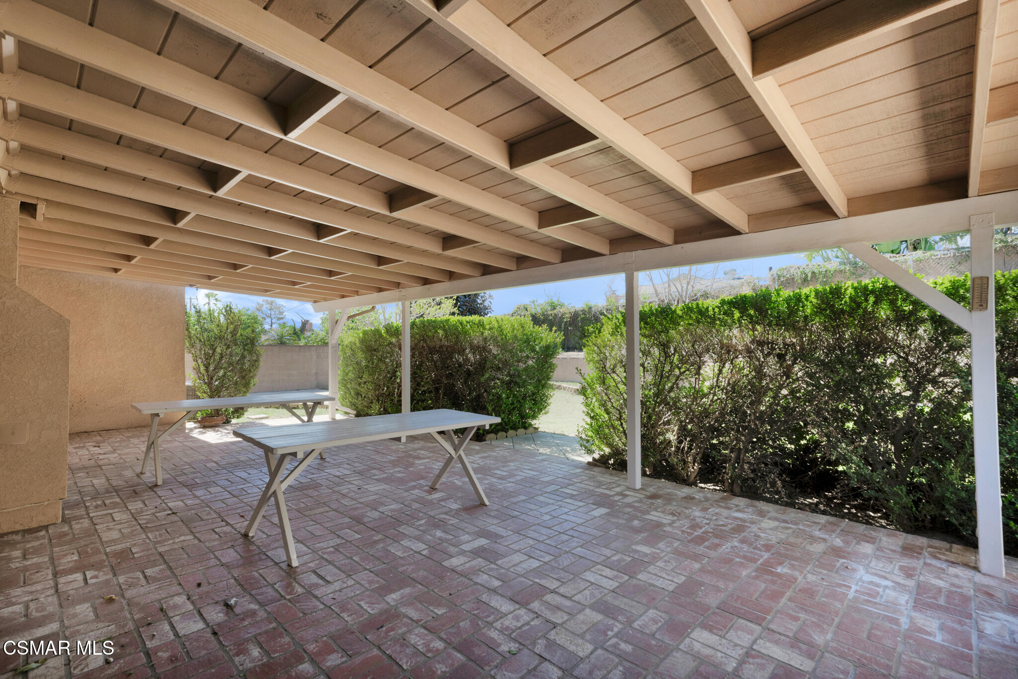 3493 Amarillo Avenue Simi Valley, CA 93063 - Photo 32 of 49 a view of a backyard with table and chairs under an umbrella with a small yard