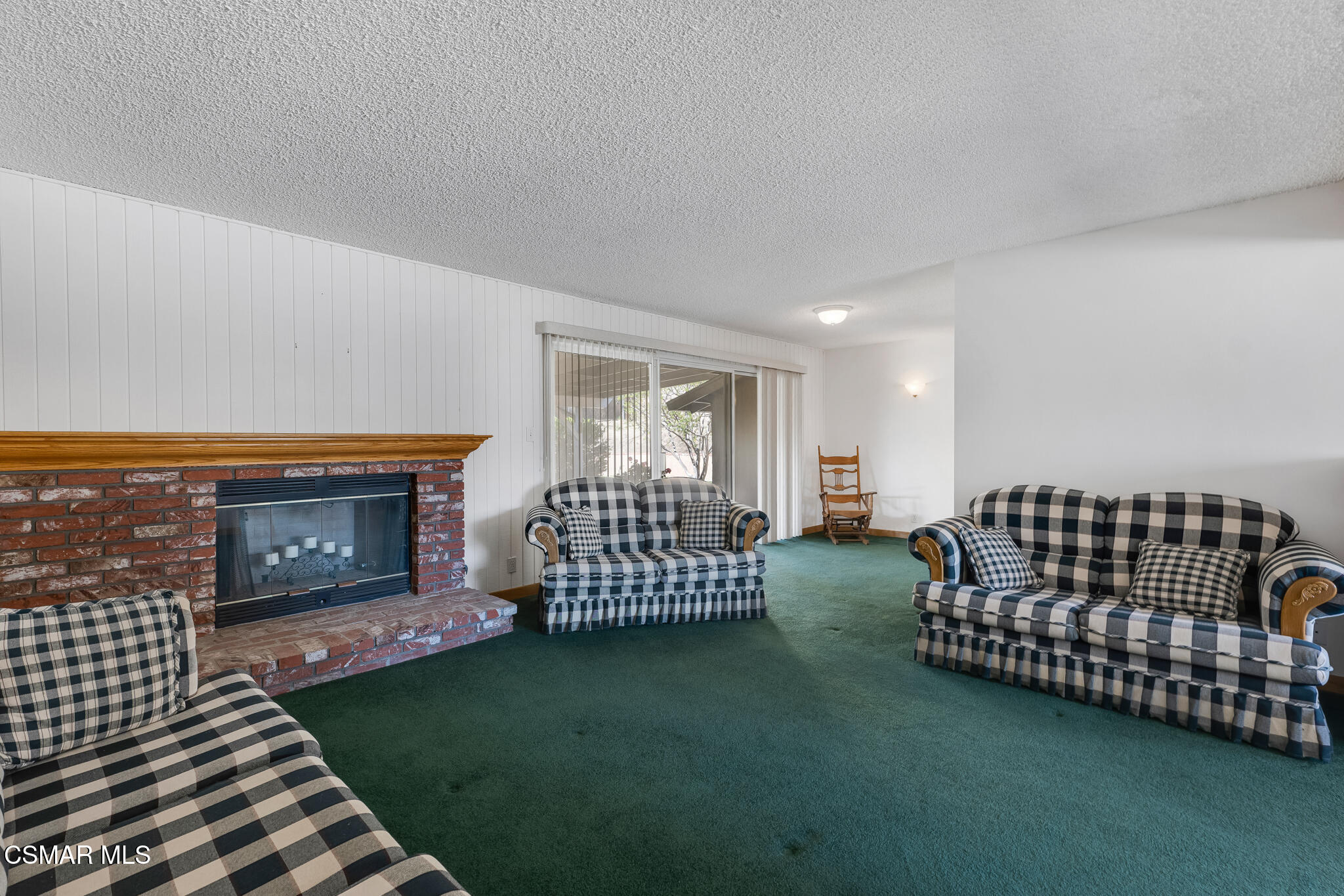 3493 Amarillo Avenue Simi Valley, CA 93063 - Photo 9 of 49 a living room with lots of chairs and a fireplace