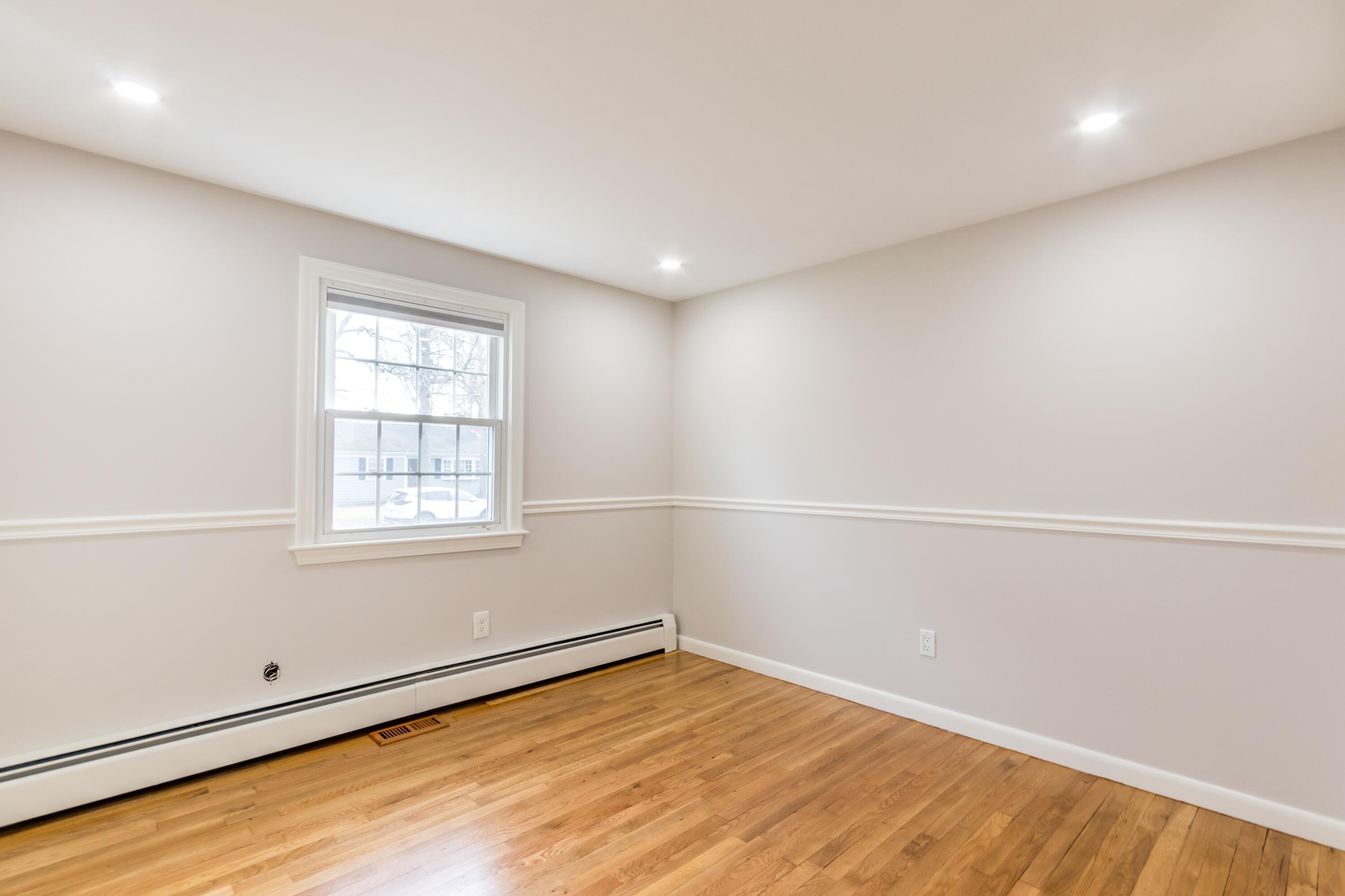 169 Megan Road Hyannis, MA 02601 - Photo 24 of 42 an empty room with wooden floor and windows