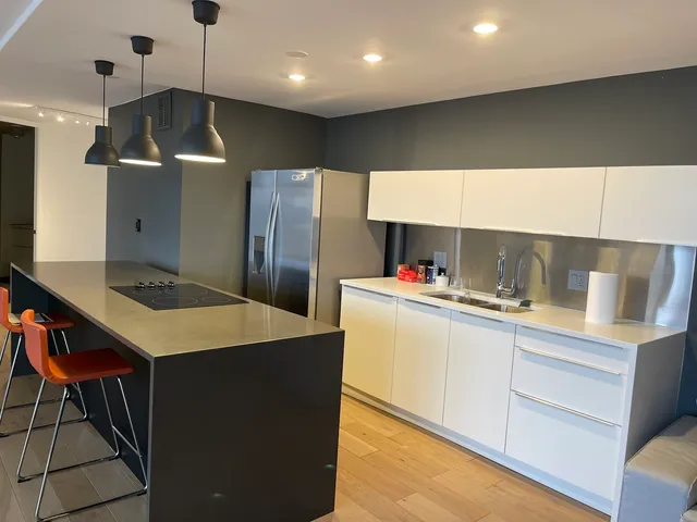 a kitchen with a sink a counter top space a stove and refrigerator