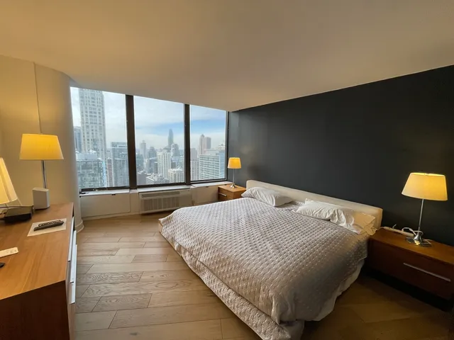 a bedroom with a bed and dresser