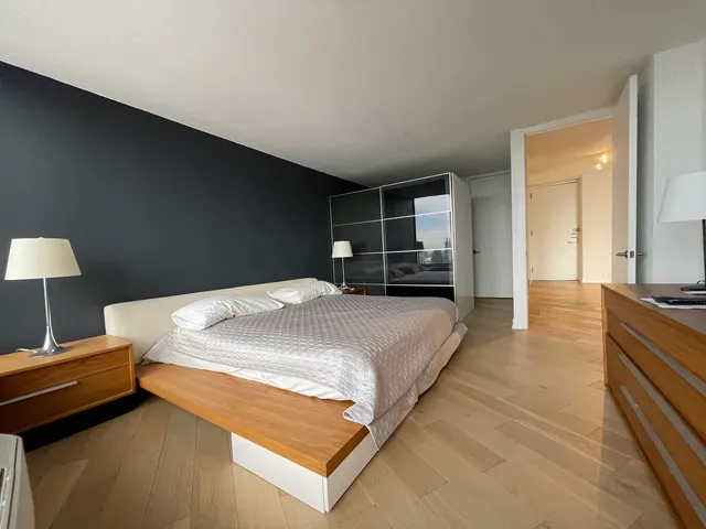 a bedroom with furniture and flat screen tv