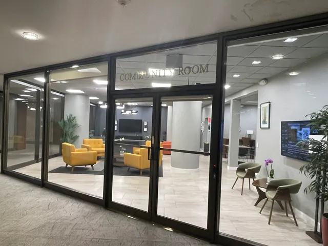 a lobby with furniture and a large mirror