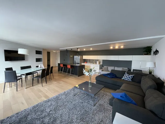 a kitchen with stainless steel appliances kitchen island granite countertop a refrigerator a stove top oven and a sink