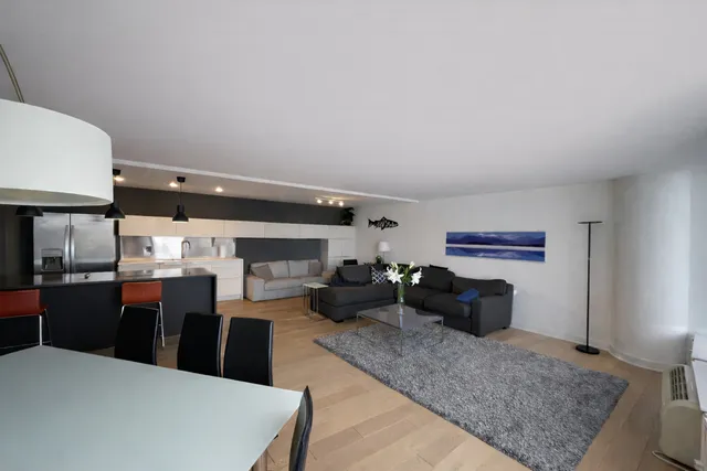 a kitchen with stainless steel appliances kitchen island granite countertop a refrigerator a stove and a sink