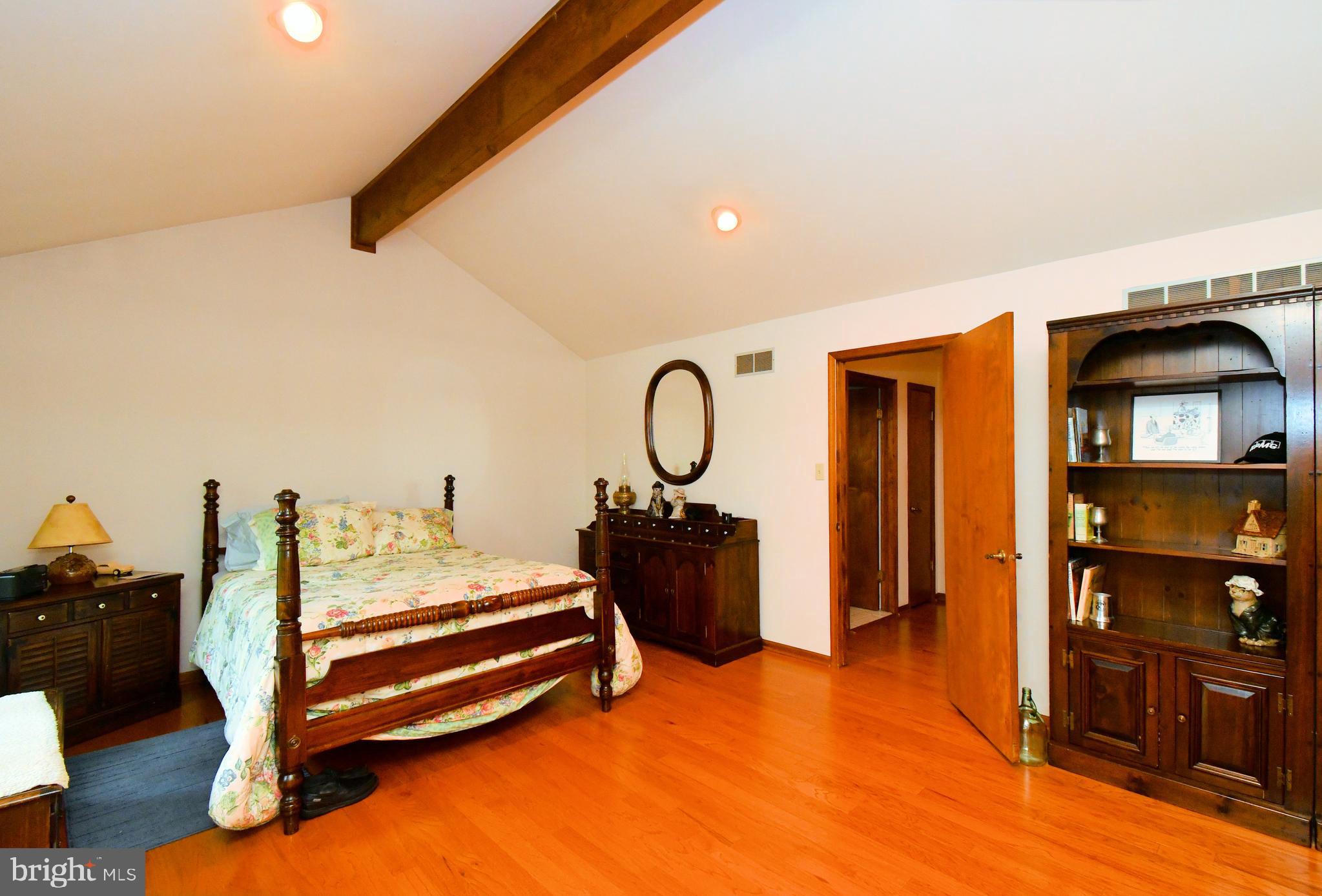 179 Almshouse Road Doylestown, PA 18901 - Photo 25 of 68 a bedroom with a bed and dresser with view of bathroom