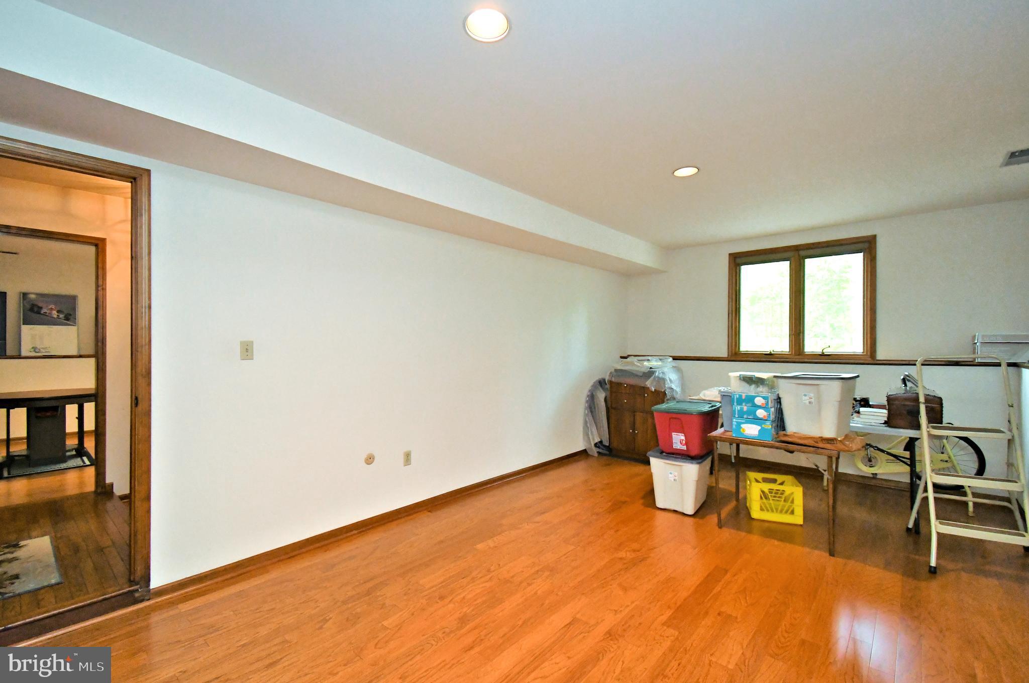 179 Almshouse Road Doylestown, PA 18901 - Photo 46 of 68 a living room with furniture and a wooden floor