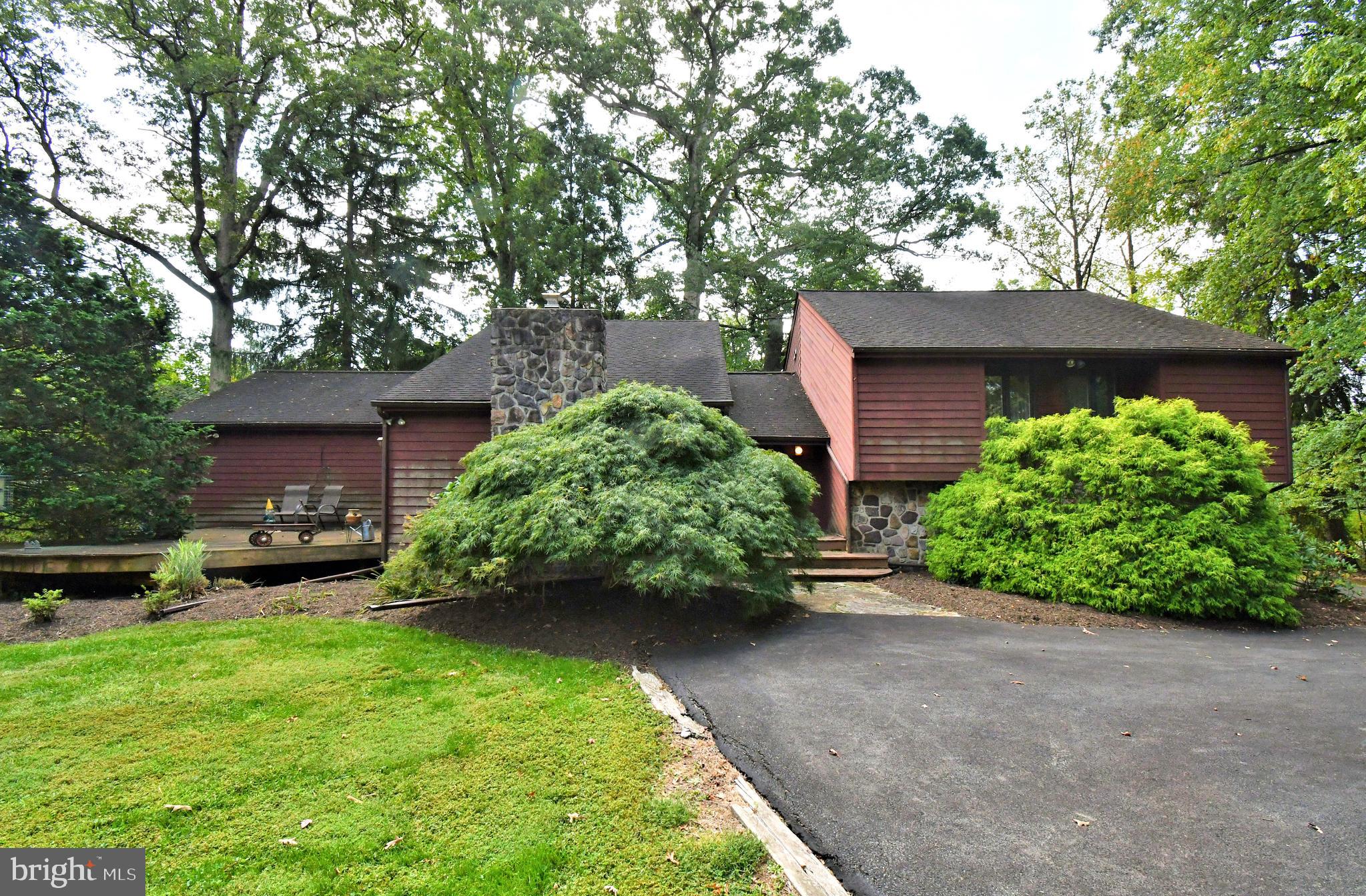 179 Almshouse Road Doylestown, PA 18901 - Photo 5 of 68 a view of a backyard with potted plants and a large tree
