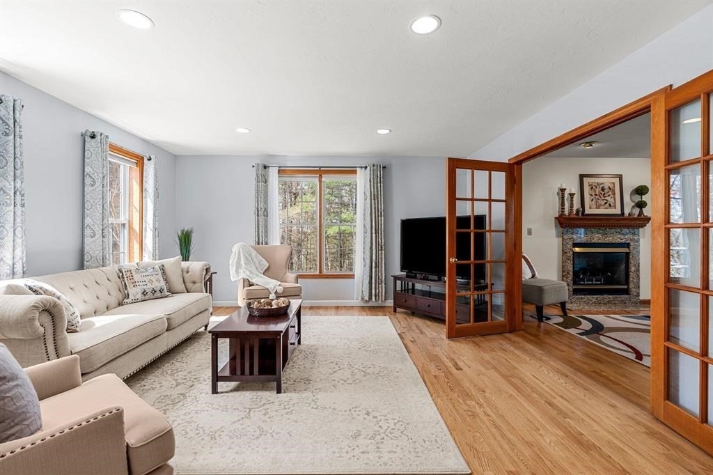 15 Lamb Road Nashua, NH 03062 - Photo 12 of 40 a living room with furniture flat screen tv and a large window