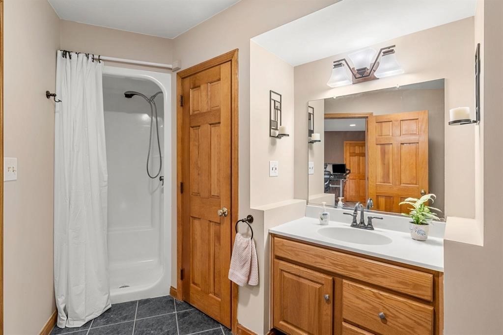 15 Lamb Road Nashua, NH 03062 - Photo 16 of 40 a bathroom with a shower sink vanity and mirror