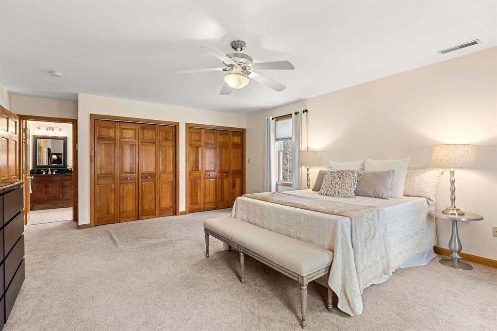 15 Lamb Road Nashua, NH 03062 - Photo 19 of 40 a spacious bedroom with a bed and a chandelier
