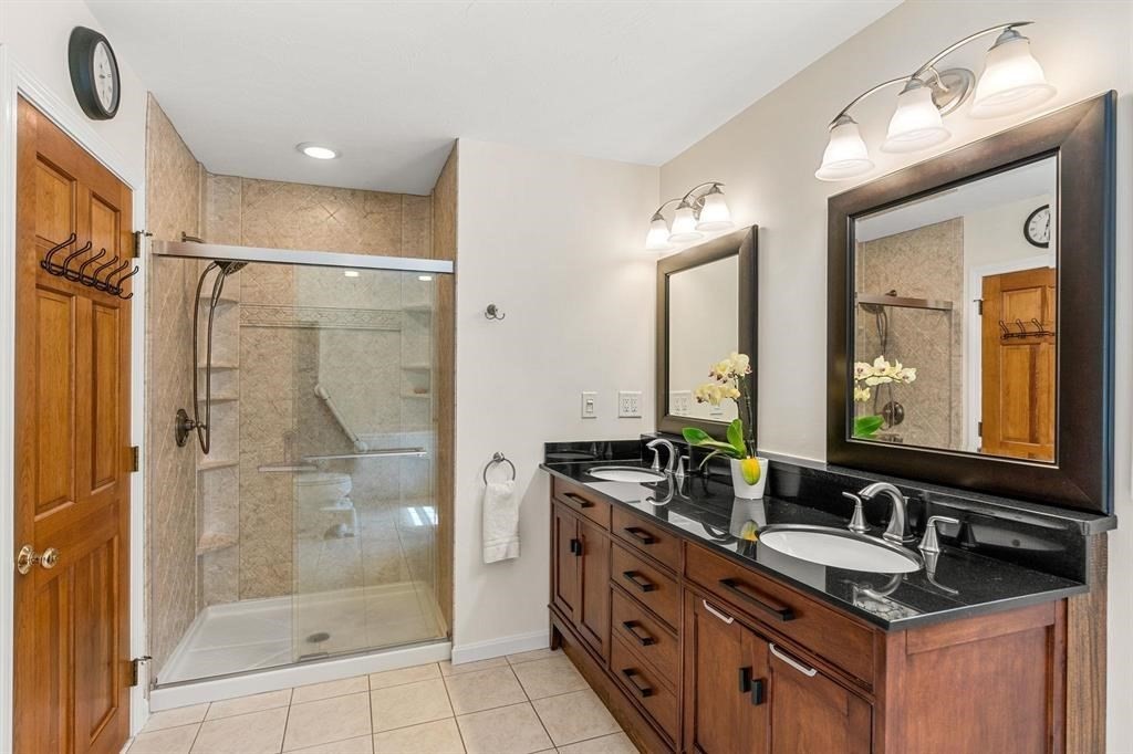 15 Lamb Road Nashua, NH 03062 - Photo 21 of 40 a bathroom with a granite countertop sink mirror and shower