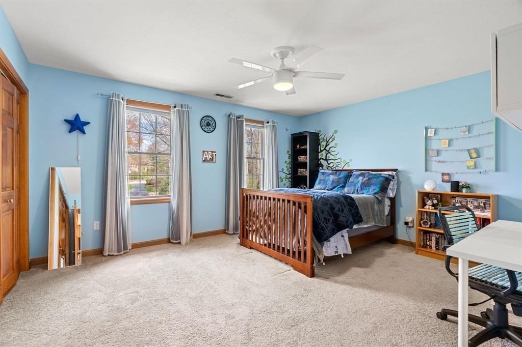 15 Lamb Road Nashua, NH 03062 - Photo 24 of 40 a bedroom with a bed and a chandelier