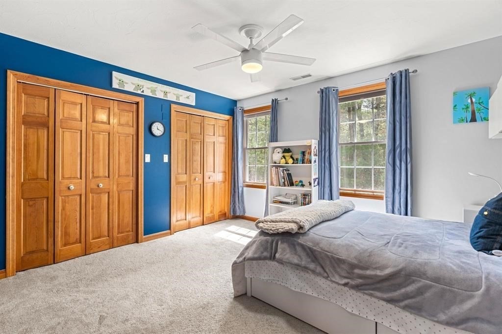 15 Lamb Road Nashua, NH 03062 - Photo 26 of 40 a bedroom with a large bed and a chandelier