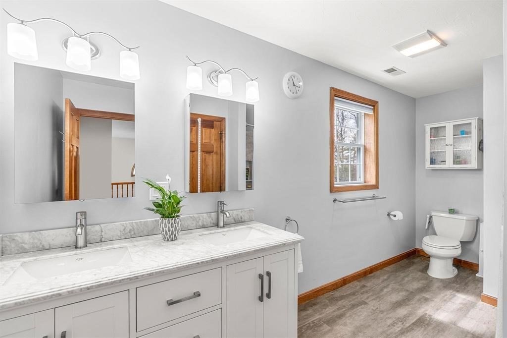 15 Lamb Road Nashua, NH 03062 - Photo 30 of 40 a bathroom with a granite countertop sink a toilet and a mirror