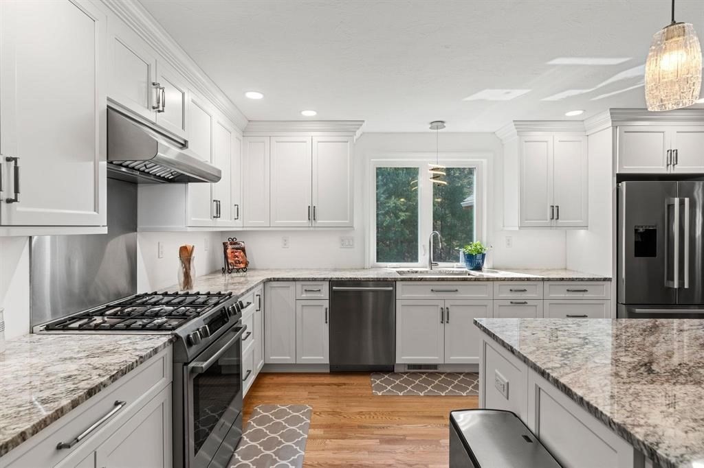 15 Lamb Road Nashua, NH 03062 - Photo 4 of 40 a kitchen with stainless steel appliances granite countertop a stove oven and a refrigerator