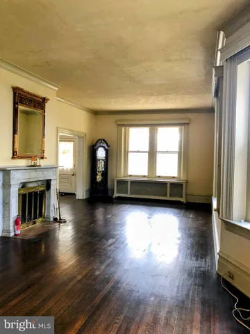 a view of a room with wooden floor and windows